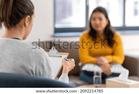 psychology, mental therapy and people concept - close up of woman psychologist and patient at psychotherapy session