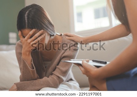 Psychology, sad asian young woman, girl cover face with hand, consulting with psychologist, psychiatrist while patient counseling mental with doctor woman taking notes at clinic. Encouraging, therapy.