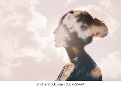 Psychology and woman mental health and weather dependent concept. Multiple exposure clouds and sun on female head silhouette. - Shutterstock ID 2037555494