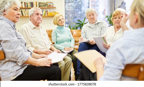 Psychotherapist in group therapy with senior citizens in a retirement home - Powered by Shutterstock