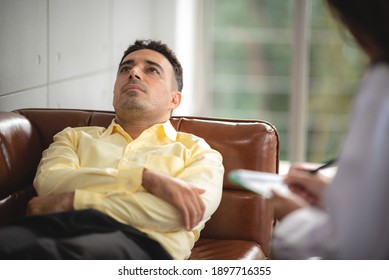 Psychotherapist is helping,listening and supporting her depressed patient at indoor office.  Healthcare treatment concept of professional psychologist doctor consult for depressed client