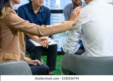 Psychotherapist Inquiring About Symptoms Occurring Within Mind From Patients With Mental Health Problems In Hospital. Group Psychotherapy For Support And Helping Worried Man To Change Negative Mindset