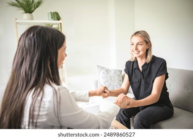 A Psychotherapist supporting depressed teenage girl on couch during appointment in office a Psychotherapy concept - Powered by Shutterstock