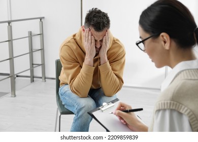 Psychotherapist working with drug addicted man indoors - Shutterstock ID 2209859839