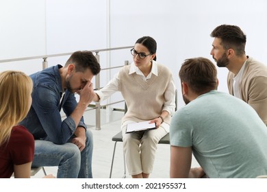 Psychotherapist working with group of drug addicted people at therapy session indoors - Shutterstock ID 2021955371