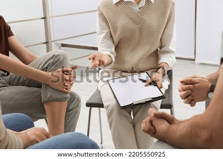Psychotherapist working with group of drug addicted people at therapy session indoors, closeup
