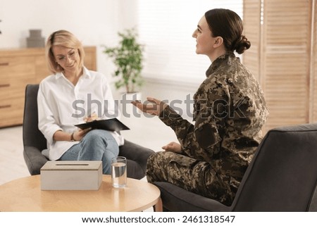 Psychotherapist working with military woman in office