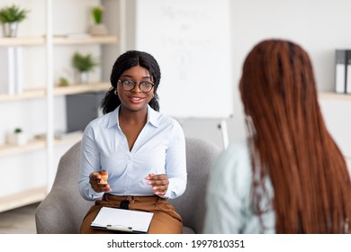 Psychotherapy consultation. Counselor talking to black woman on meeting at office, giving advice to young client. Friendly African American psychologist having session with female customer - Shutterstock ID 1997810351