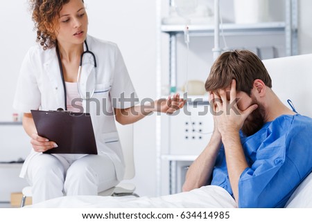 Psychotherapy nurse helping crying patient with panic disorder