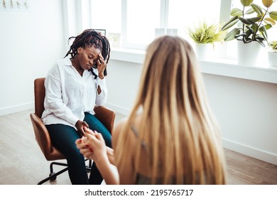 Psychotherapy Session, Woman Talking To His Psychologist In The Studio. Young Woman Visiting Therapist Counselor. Girl Feeling Depressed, Unhappy And Hopeless, Needs Assistance. Serious Disease