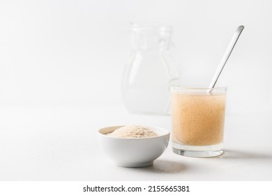 Psyllium husk and glass of water soluble fiber supplement for intestinal on white background. Superfood for healthy, lowers cholesterol, boosts weight loss. - Shutterstock ID 2155665381