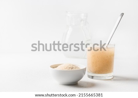 Psyllium husk and glass of water soluble fiber supplement for intestinal on white background. Superfood for healthy, lowers cholesterol, boosts weight loss.