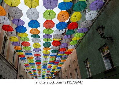 Pszczyna, Silesia, Poland 07.22.2021. Colorful Umbrellas Hung Above The Street By The Market Square.
