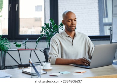 ptosis, eye syndrome, bold african american businessman using laptop, dark skinned office worker with myasthenia gravis disease, diversity and inclusion, corporate culture, startup