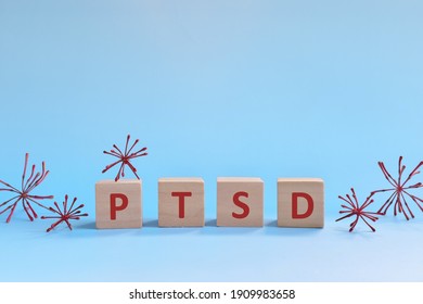 PTSD Letters In Wooden Blocks On Blue Background. Coping With Anxiety, Stress, Ptsd And Depression During Covid-19 Pandemic Concept.