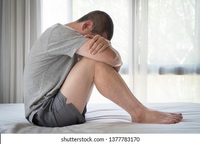 PTSD Mental health concept - Depressed Man with Problems sitting alone head in hands on the bed and Crying. Psychological trauma, Erectile, Frustration, Miserable, 
Despair, Men health concept.
