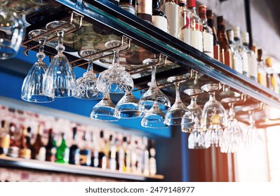 Pub, alcohol bottle and upside down glasses in restaurant for cocktail, wine or whiskey. Bar, room or interior of empty club for drink, champagne or beverage with luxury design at hotel on background - Powered by Shutterstock