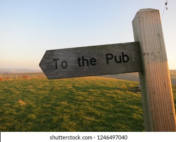 To The Pub Wood Public Right Of Way Sign Post.sunset On The Downs . England. UK