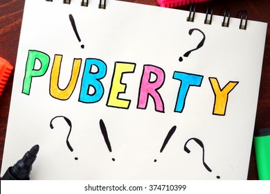 Puberty written on notepad on a table. - Shutterstock ID 374710399