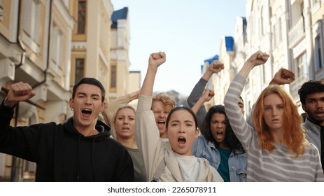 Public demonstration of student activists at city street. Arms raised in protest. - Powered by Shutterstock