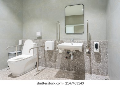 Public Disabled Toilet In A Large Building. Modern Restroom For Disabled People. Inside Disable Toilet Or Elderly People. Handrail For Disabled And Elderly People In The Bathroom.