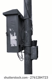 Public electrical panel located on the side of the road. full of advertising stickers and 2 used coffee cups.