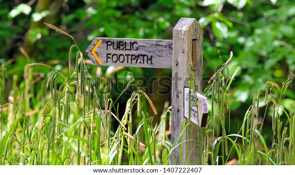 Public foot path signs spotter while walking on another\
footpath. 