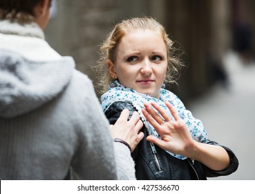 Public harassment: annoying man chasing  irritated young girl  - Shutterstock ID 427536670