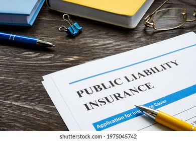 Public liability insurance empty application on wooden surface.