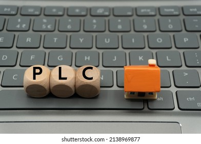 Public Limited Company (PLC) Is A Public Company In The United Kingdom.word Is Written On Dice, Next To House.