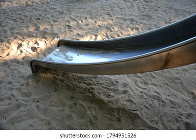 Public Multifunctional Playground With A Sandy Impact Zone And A Stainless Steel Slide In The Park With A Sandpit, A And A Rope Ladder For The Children's 