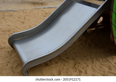 Public Multifunctional Playground With A Sandy Impact Zone And A Stainless Steel Slide In The Park With A Sandpit, A And A Rope Ladder For The Children's 