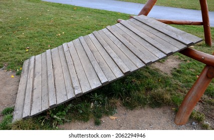 Public Multifunctional Playground With A Sandy Impact Zone And A Stainless Steel Slide In The Park With A Sandpit, A And A Rope Ladder For The Children's 