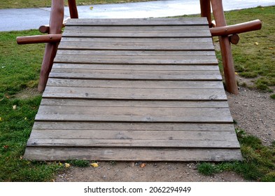 Public Multifunctional Playground With A Sandy Impact Zone And A Stainless Steel Slide In The Park With A Sandpit, A And A Rope Ladder For The Children's 