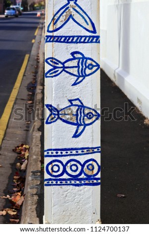 Public non proprietary unsigned artwork commissioned by city, graffiti on public street post in North Adelaide, Australia 