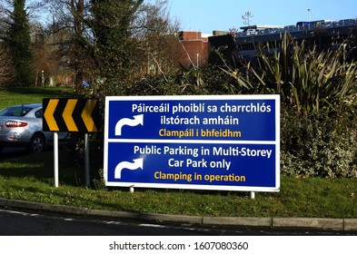 'Public Parking In Multi-Story Car Park Only, Clamping In Operation' Sign In English And Translated Into Irish Language In Beaumont Hospital, Dublin, Ireland. 