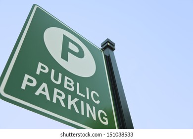 A Public Parking Sign Shot From Below With Blue Sky.