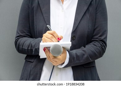 Public Relations - PR Officer At Media Event Holding Microphone Taking Notes, Preparing Press Release