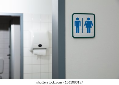 Public Restroom With Male And Female Toilet Sign On White Wall