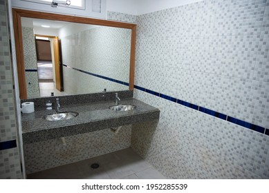 Public restrooms of the school. with modern design, new hand wash, beautiful colored tiles, faucet with mirror and window.