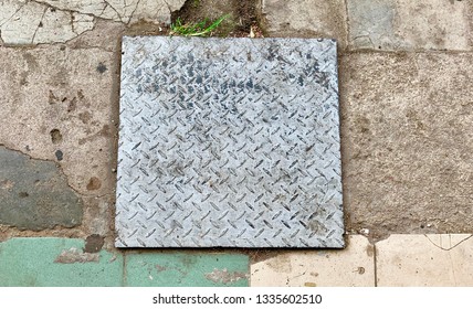 Public Road Cracking And Sinking Around Drain Access Cover Giving A Large Pot Hole .