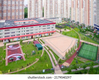 Public School Building. Exterior View Of School Building With Playground Mixed-use Urban Multi-family Residential District Area Development. Back To School Concept.