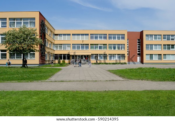 Public school building. Exterior view of\
school building with\
playground.