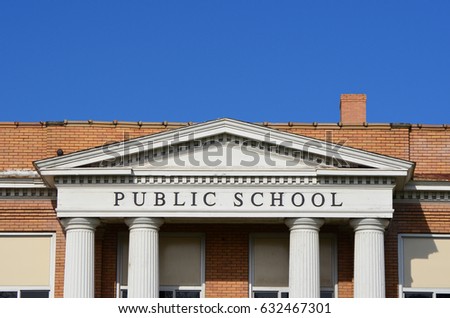 Public school sign on a traditional school entrance 