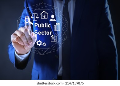 Public Sector Concept. Man Pointing At Virtual Screen With Different Icons On Blue Background, Closeup