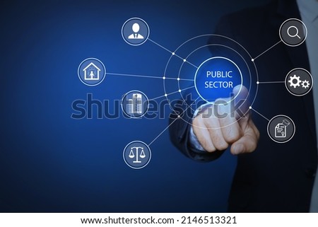 Public Sector concept. Man pointing at virtual screen with different icons on blue background, closeup