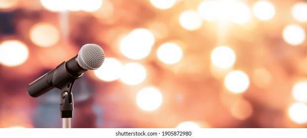 Public Speaking Backgrounds, Close-up The Microphone On Stand For Speaker Speech Presentation Stage Performance With Blur And Bokeh Light Background.