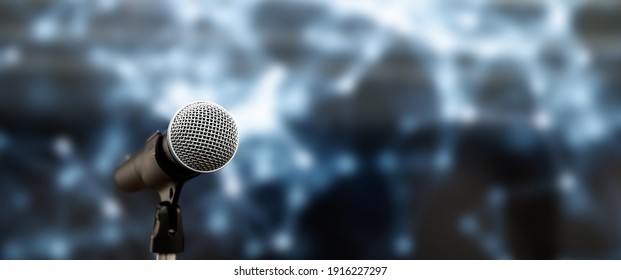 Public Speaking Backgrounds, Close-up The Microphone On Stand For Speaker Speech Presentation Stage Performance With Blur And Bokeh Light Background.