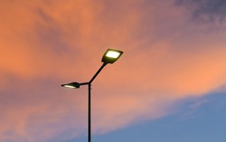 Public Street Lighting Pole With LED Lights With An Amazing Sunset Color Background.