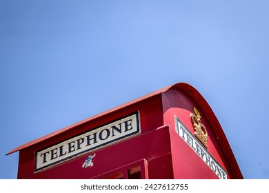 public telephone booth with blue sky background
